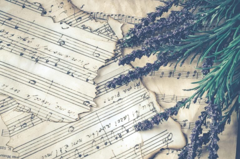 Aesthetic composition of lavender flowers on old music sheets, evoking nostalgia.